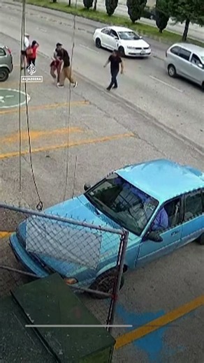 Moment shop worker dives into traffic to save child