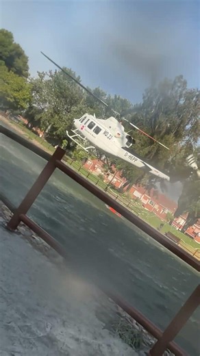 Firefighting Helicopter Scoops Water From Park Lake
