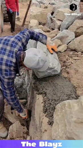 Skilled Masons Installing Massive Stones in Perfect Alignment Using Cement