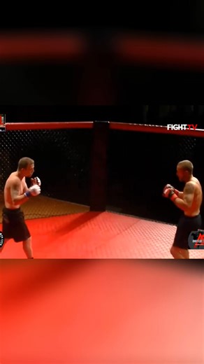Witness the raw intensity as two fighters go head-to-head in a caged octagon. Experience the grit and determination as they exchange punches under the bright lights. A true test of skill and endurance. #MMA #Fighting #CombatSports #Octagon #Fighters | FIGHT.TV