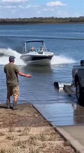 Boat Launch Mishap Leaves Truck and Vessel Severely Damaged After Failed Trailer Attempt Lake Okeechobee FL Phone footage captured at a public boat ramp shows a routine retrieval attempt spiraling into a costly accident when a female driver applied excessive throttle while trying to load a boat onto the trailer. The scene unfolds on a calm, clear day as the pickup truck is backed down the concrete ramp toward the water. As the boat approaches the trailer, the driver accelerates in an apparent ef