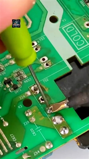 The video shows a soldering iron being used to create an electrical connection on a printed circuit