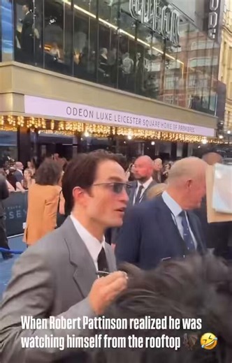 Robert Pattinson reacts to seeing a Batman statue on a rooftop at ‘THE ODYSSEY’ premiere.“How did that happen??”