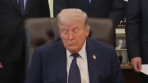 President Donald Trump appears to close his eyes during Oval Office announcement