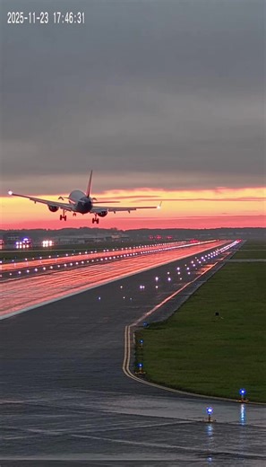 A dramatic aviation emergency unfolded at sunset when a commercial jet experienced a catastrophic failure moments after liftoff, sending the aircraft pitching sharply upward before slamming back toward the runway in a cloud of smoke and fire. The incident was captured by fixed airport cameras as the aircraft attempted to depart under fading daylight and slick runway conditions. The footage opens with the jet accelerating down a long, illuminated runway as dusk paints the sky in orange and pink h