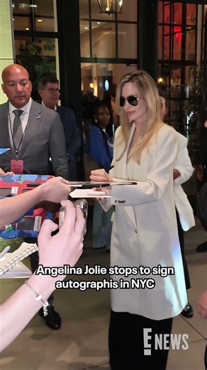 Angelina Jolie stopped for fans to sign autographs as she left a screening of her new film "Couture"