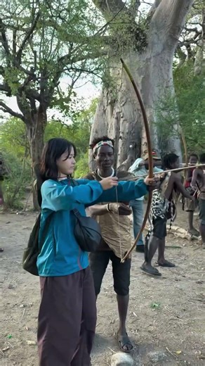 Hadzabe bushmen teaching visitors about their ancient ways of living in the bush