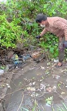 Removing All the Trash to Drain a Flooded Street During Heavy Rain