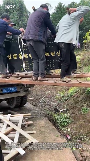 "Ancient Wisdom in Action! 🔥 Masters Carry Heavy Stone Tablet Across Narrow Plank Bridge"