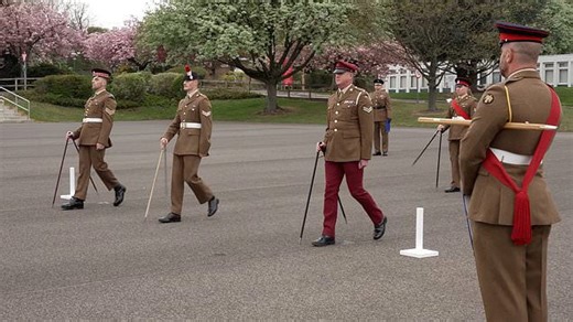 Soldiers compete to see who can walk in the straightest line with a pair of compasses