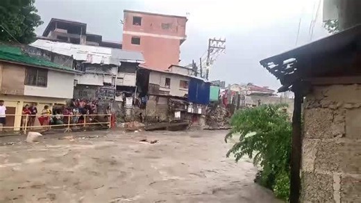 Flash flood in the Philippines carries away rubbish after river bursts its banks