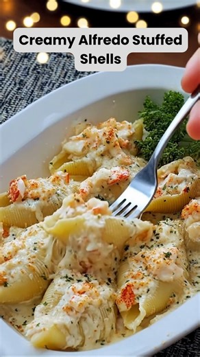 Creamy Alfredo Stuffed Shells What if all the comfort of cheesy Alfredo pasta, buttery seafood, and oven-baked goodness lived in one irresistible bite? These Creamy Alfredo Stuffed Shells do exactly that—and once you try them, plain pasta will never feel the same again. Ingredients For the Pasta & Filling 20–24 jumbo pasta shells 1 lb cooked lobster or shrimp (or a mix), chopped 1 cup ricotta cheese 1 cup shredded mozzarella cheese ½ cup grated Parmesan cheese 1 egg 2 cloves garlic, minced 1 tsp