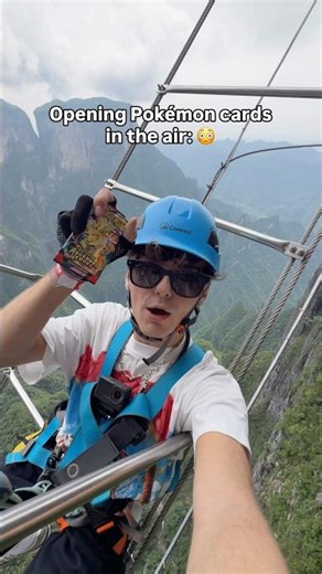 Opening Pokémon cards in the air: