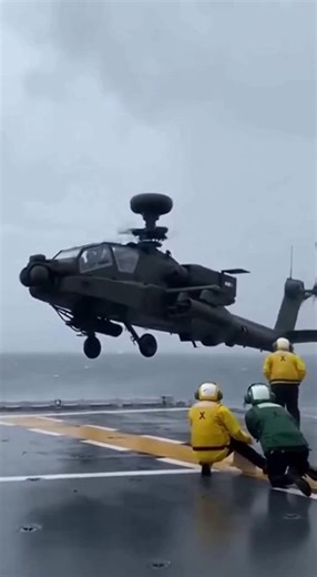 Lightning Strike Sends Military Helicopter Crashing on Storm-Soaked Deck At Sea — A violent storm turned a routine flight operation into a terrifying emergency when a military attack helicopter was struck by lightning moments before losing control and crashing onto a ship’s deck, sending sparks, debris, and crew members scrambling for cover. The video captures the helicopter hovering low over the deck as rain lashes the surface and wind whips across the open water. Suddenly, a bright bolt of lig