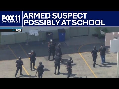 Reports of armed suspect possibly at school