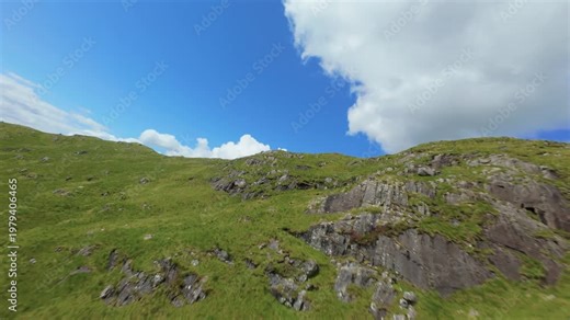 An FPV drone threads its way along the towering concrete face of the Cruachan Reservoir dam above Loch Awe, racing past steep green slopes and still mountain waters—delivering a dynamic, immersive aer