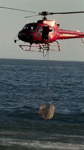 Helicopter rescuing drowning people in Copacabana Beach, Rio de Janeiro, Brazil 2025. The person still left in the water is a lifeguard who helped the people in the rescue basket and swam safely to shore on his own.