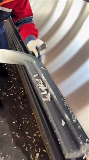 The process of cutting the edges of honeycomb aluminum panels.