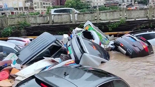 Floating cars packed together on severely flooded road in China