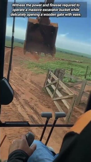 Skillful Excavator Operator Using Bucket To Open Gate Latch