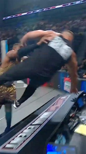 The Street Profits send Bron Breakker crashing into the table