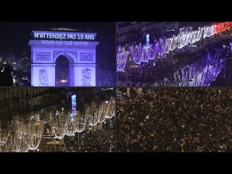 Crowd gathers on the Champs Elysées to watch New Year's Eve fireworks | AFP