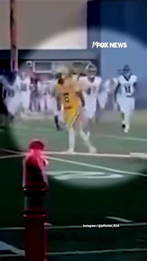 WATCH: High school football player EJECTED after hitting player holding American flag