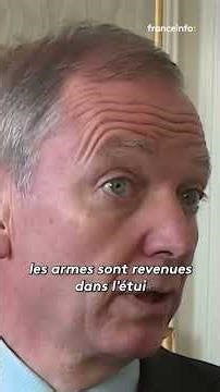 Police officers point their weapons at a farmer