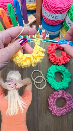 Crochet scrunchies, in this tutorial from Naztazia, are so fast and satisfying to make. We work simple stitches right over an elastic to create this beautiful hair accessory. #reels #crochet #knitting #artist #yarn #makersgonnamake #scrunchies #tutorial #crocheting #crochetinspiration #naztazia | Naztazia