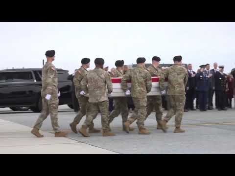 Trump dons baseball hat as he joins families for the return of soldiers killed in the Middle East