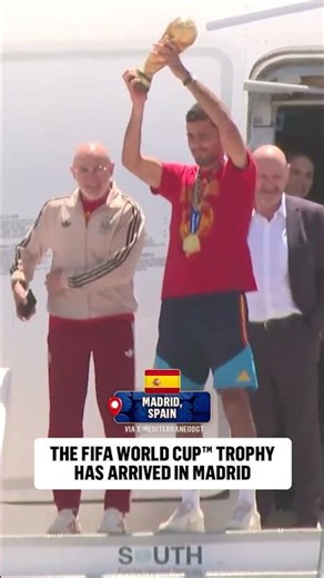 Luis de la Fuente and Captain Rodri present the FIFA World Cup trophy after arriving back in Spain