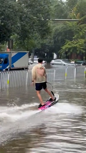Residents kayak and surf through floodwaters in China