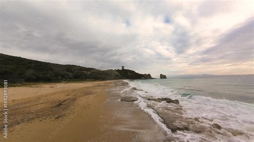 Fast FPV Drone Low Flight and Near the Waves, Over Fwlia Beach with Apollonia Tower in Background, Kavala Greece