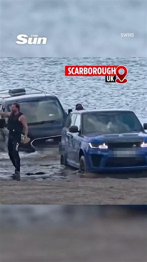 Moment £120k Range Rover is submerged by rising tide after owner gets luxury SUV stuck in sand