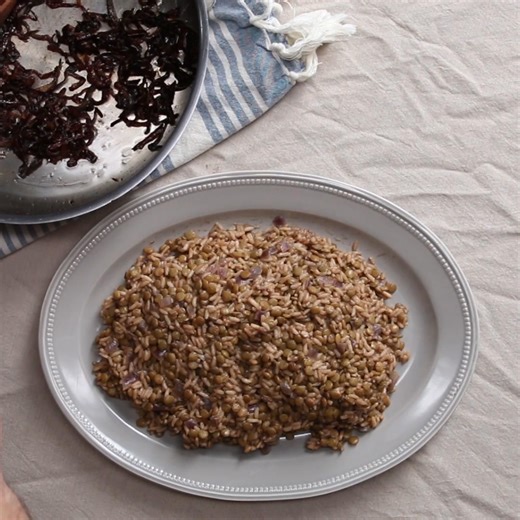 Lentils and rice cooked together with herbs and spices, topped with caramelized onions, fresh parsley, and lemon. | Tasty