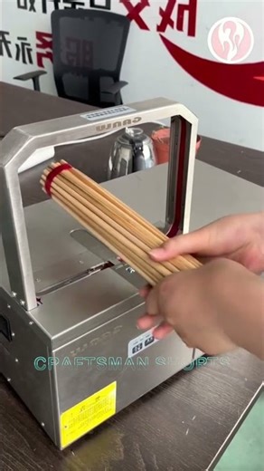 Strapping Machine | A small strapping machine is strapping chopsticks together.