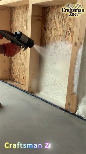 Indoor partition of wooden house is sprayed with foamed polyurethane foam