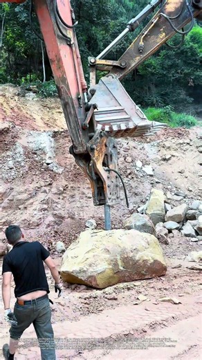 Huge rock drilling work, excavator hydraulic hammer supports drill, satisfying heavy construction