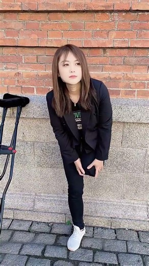 Grace SAK amputee standing outside massaging her stump