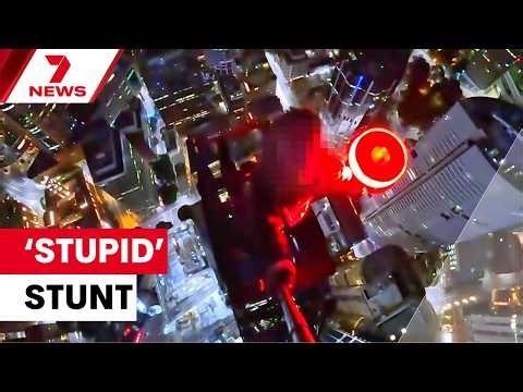 Daredevil climbs crane on top of Sydney skyscraper | 7NEWS