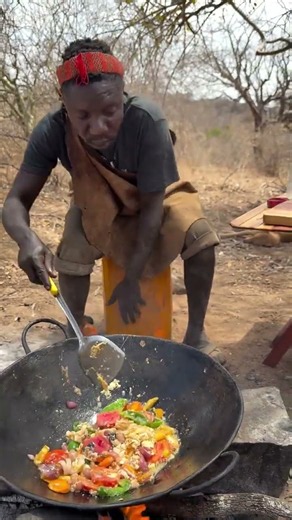 Hadzabe bushmen Chabba try cooking new veggies first time in the bush