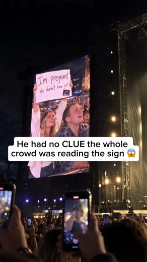 Crowd Reads Sign Surprise at Country Music Show