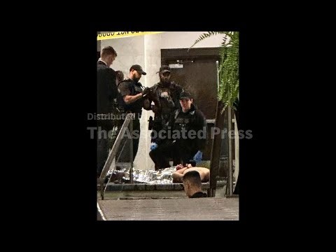 Law enforcement officers control shooting suspect during the White House Correspondents Dinner