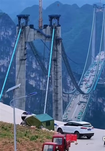 This is China’s Huajiang Canyon Bridge ..it is the highest bridge in the world….And I’d be on the floorboards of the car if I ever had to cross over a bridge like this .