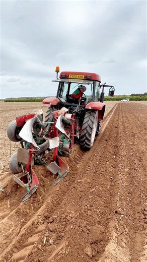 McCormick CX105 tractor with a Kverneland match plough