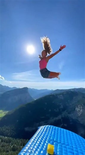 Cliffside Bounce: Epic Leap onto Inflatable! 😱 #ExtremeSports #Adventure #CliffJumping