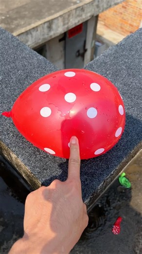 Experiment: Will a water balloon explode if it rolls down a tall building? 💥🎈 #balloon