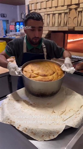 Şah Plov 📍Azerbaijan 🇦🇿 Video: @nudretliikin Şah Plov, translating to “Crown Pilaf,” is the majestic centerpiece of Azerbaijani cuisine, traditionally reserved for weddings, festive banquets, and grand celebrations like Novruz. Acting as the ultimate expression of hospitality, this impressive dish consists of fragrant, saffron-infused basmati rice baked inside a crispy, golden shell made from layers of buttered lavash flatbread. The crust, known as gazmakh, seals in the rich aromas and moistu