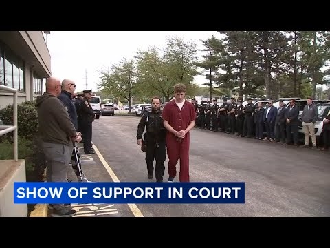 Police show solidarity as suspect in officer assault appears in court