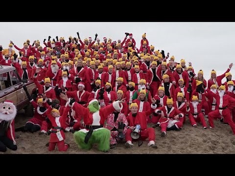 WATCH: Surfin' Santas Spread Christmas Cheer on Chilly North Sea Waves | CHRISTMAS CELEBRATION
